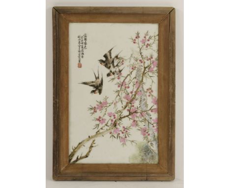 A famille rose ceramic plaque,20th century, painted with swallows amongst blossoming branches, inscribed, dated Summer Year o