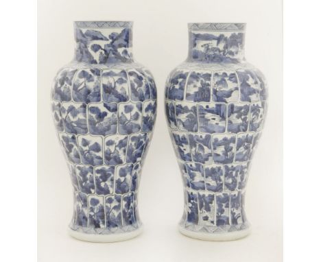 A pair of Chinese porcelain blue and white vases,Kangxi (1662-1722), of baluster form, each painted with numerous panels of t