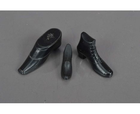 A group of three 19th Century novelty shoe shaped items, Including a boot carved from Whitby jet (possibly a pipe tamper, sli