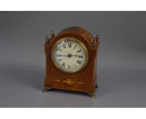 A neatly sized 20th Century dome top mahogany mantle clock,  with brass finials and feet, inlaid edge and marquetry detailing