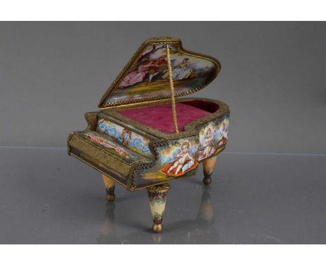 A Viennese enamelled gilt metal miniature piano shape music box, Austrian circa 1900. Decorated inside and out with a scene o