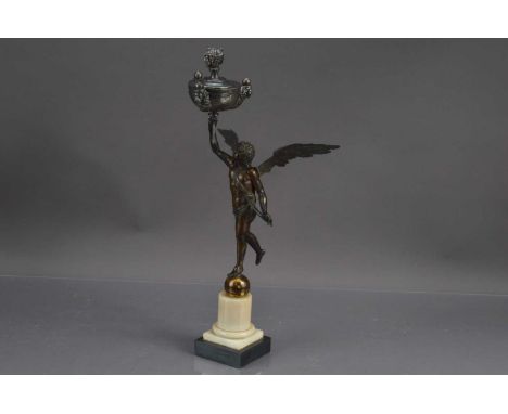 An unusual antique bronzed sculpture of a neoclassical winged angel, the figure standing on a ball holding in right hand a si