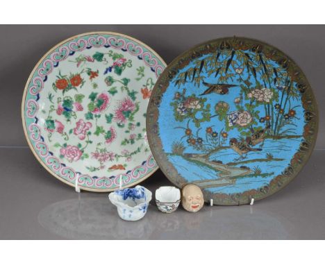 Five Oriental items including a famille rose plate, a cloisonne enamel charger a Canton enamel wine cup, an interesting porce