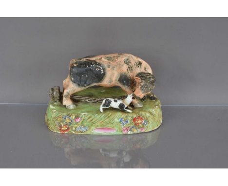 A 19th century Staffordshire pottery group, damaged, modelled as a bull with a dog, chips and losses, 24.5cm wideThe group is