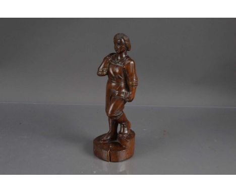 A hand-carved hardwood Art Deco era sculpture of a female factory worker, the figure of a young woman in work clothes with du