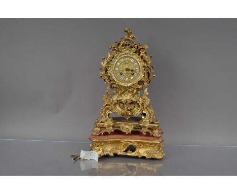A Victorian period brass mantle clock on stand, Louis XV style with eight day movement, total height 42cm (2)