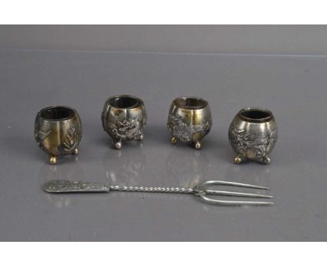 Four Chinese Silver Salts and a Chinese silver bread fork, The salts of melon shape on three ball feet with dragon and flamin