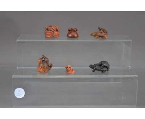 Six Japanese wooden netsuke carved as turtles, one example with a turtle carrying four turtles on its back signed Gyokuzan
