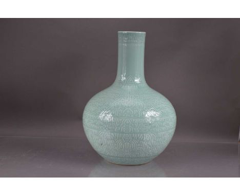 A very large Chinese celadon porcelain vase, onion shape character mark in blue to base. Labels for E &amp; J Frankel Collect