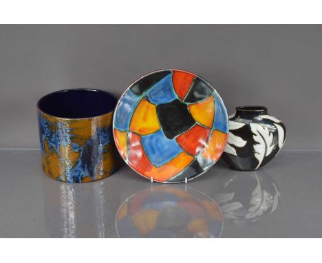 Three second half 20th century pottery items, including a bright coloured plate, 26.5cm, probably Poole Pottery, a West Germa