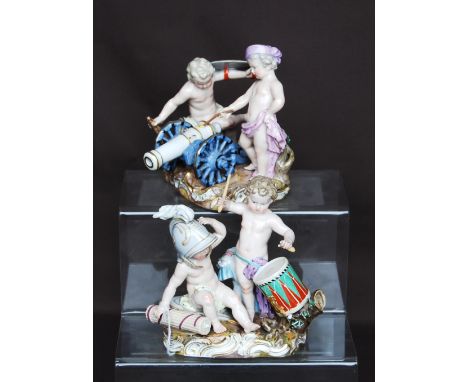 Pair of Meissen figure groups, each of two semi clad children playing at soldiers, one group with a child beating a drum (los