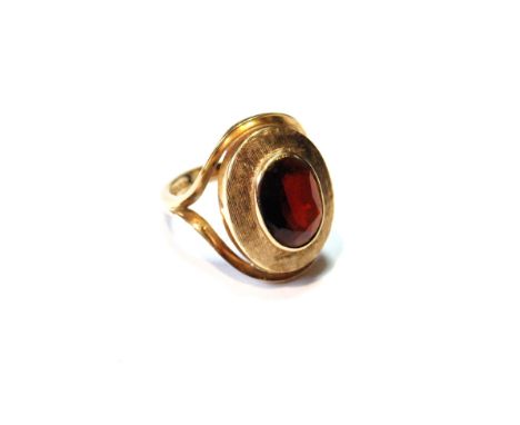 Dress ring with oval garnet on textured band, 9ct gold, 1974, size L. 