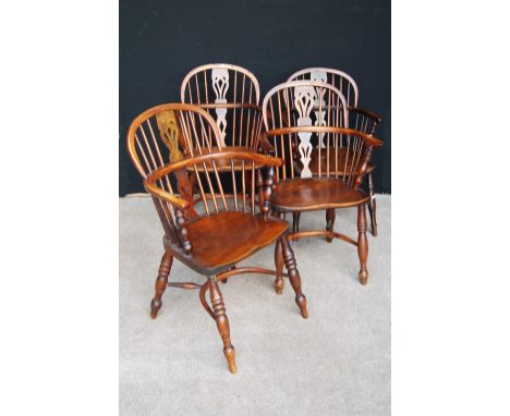 Near-set of four yew Windsor chairs, each with comb back, pierced fiddle splat, hoop arms and raised on splayed baluster turn