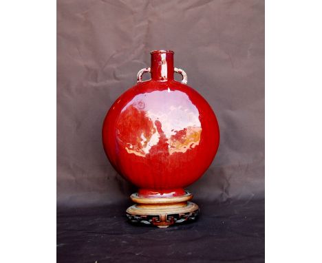 Chinese 19th century large moon flask with sang de boeuf glaze, loop handles and wooden stand, 31cm high.CONDITION REPORT:Thi