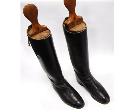 Pair of vintage leather riding boots and stretchers.The base of the foot is 29.5cm long and 10cm wide.  The height of the boo