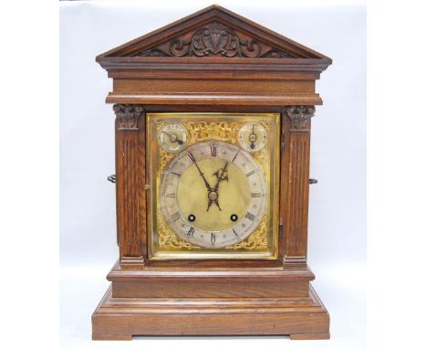Late 19th century oak cased Palladian mantel clock of classic form with brass face, applied spandrels and chapter ring, Roman