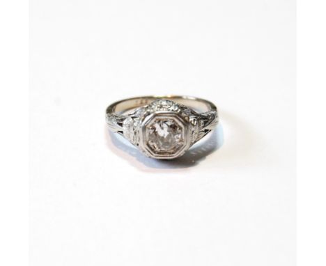 Diamond solitaire ring with brilliant, approximately .6ct, in octagonal setting with pierced and engraved flowers and sprays,