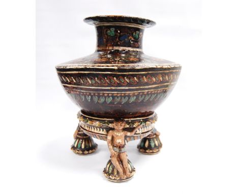 Iznik style pottery vase with floral decoration over brown glaze and raised on tripod base, 20cm wide and 28cm high.CONDITION