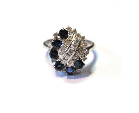 Dress ring with six oval and round sapphires and brilliant diamonds in scrolls, 18ct white gold, size V. 