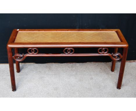 Chinese early 20th century long side table with woven bamboo top with scroll frieze and tapering circular supports, 105cm wid