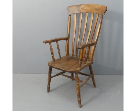 A 19th century elm-seated Windsor stick-back open armchair.