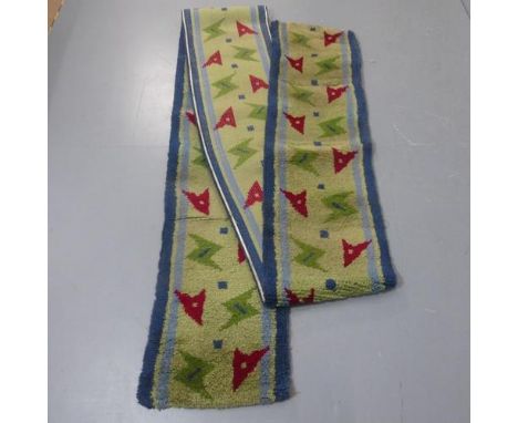 A mid-century hand tufted carpet runner with abstract arrow head design. Length 285cm, width 48cm.