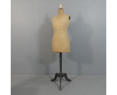 A French shop mannequin on painted tripod stand, marked Stockman. Height 160cm.