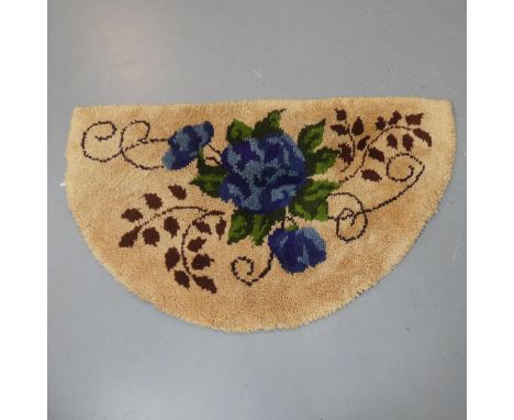 A mid-century demi-lune tufted wool rug with botanical design. Length 130cm, width 76cm.