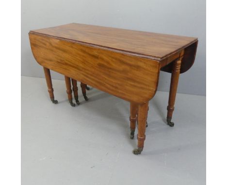 A George IV or Regency figured mahogany extending dining table, the drop flap end sections opening with Wilkinson scissor or 