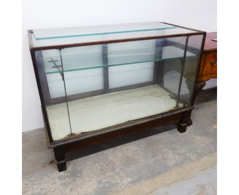 A mahogany framed glazed shop display counter, with one adjustable shelf, spare shelf and bracket. Width 117cm, height 90cm, 
