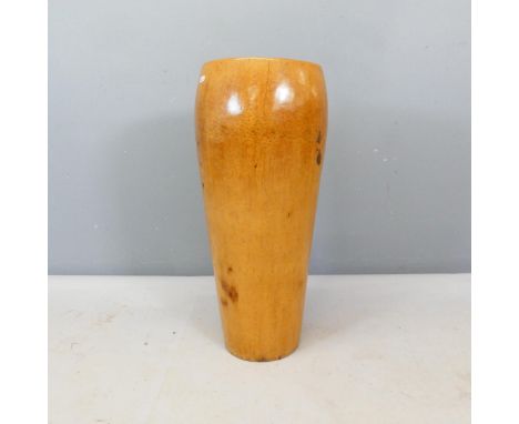 A turned wooden stick stand.