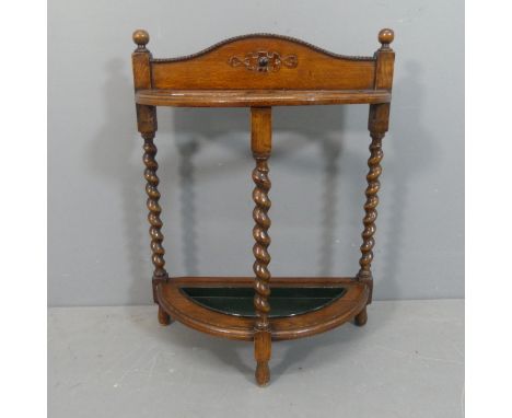 A 1930s oak stick / umbrella stand, with barley twist supports and original drip tray. Width 58cm, height 76cm, depth 26cm.