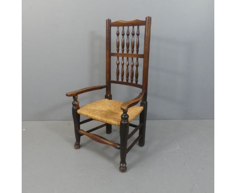 A North Country style rush seated open arm chair, with bobbin turned back.