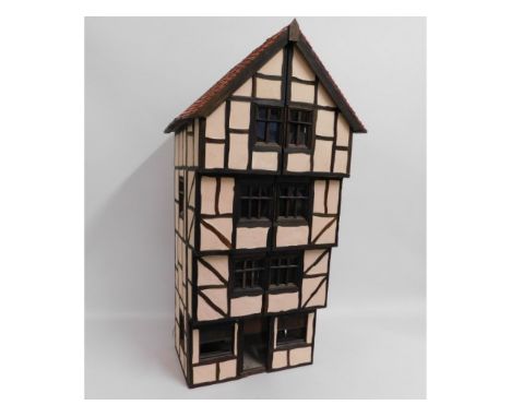 A Tudor dolls house over four floors, lighting fitted, 38.5in high x 15.25in wide