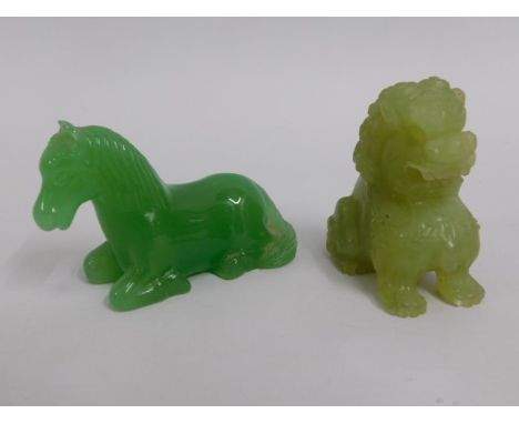 A carved Chinese jade horse twinned with a carved soapstone foo dog, tallest 2.25in