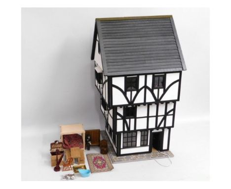 A Cornish made Tudor style dolls house twinned with dolls house fittings &amp; furnishings, with lighting, 36.25in tall x 19.