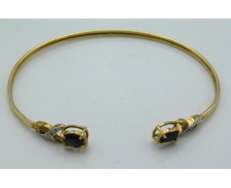 A 9ct gold bangle set with sapphire &amp; diamond, 65mm wide, 3.9g