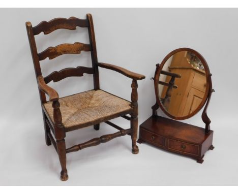 An oak low level rush seated ladder back chair, 31.5in high to back, twinned with a 19thC. mahogany dressing table mirror, 25