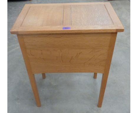 A light oak sewing box on square legs
