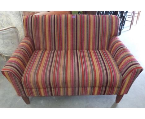 A small John Lewis sofa upholstered in brightly coloured striped fabric. 50' wide