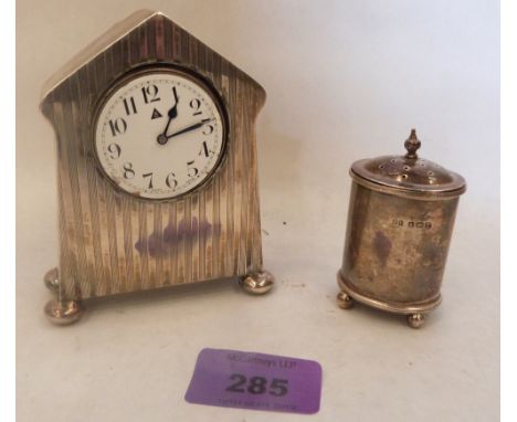 A silver engine turned dressing table clock and a silver pepperette