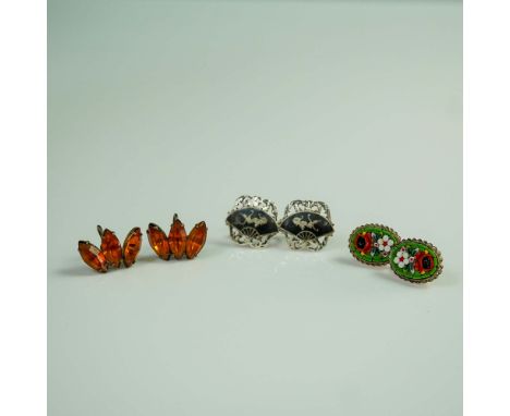 Set of three vintage screw-back earrings, each reflecting unique mid-century style and craftsmanship. The first pair features