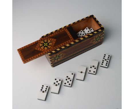 This vintage domino set includes black and white domino tiles housed in an intricately inlaid marquetry wood box with a slide