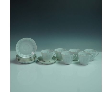 A 12-piece porcelain tea set in the Oksa rice grain pattern by Arabia of Finland, designed by Friedl Holzer-Kjellberg. This r