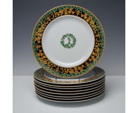 Refined set of nine porcelain dinner plates crafted with an outer border of yellow and green foliage on a black ground. This 
