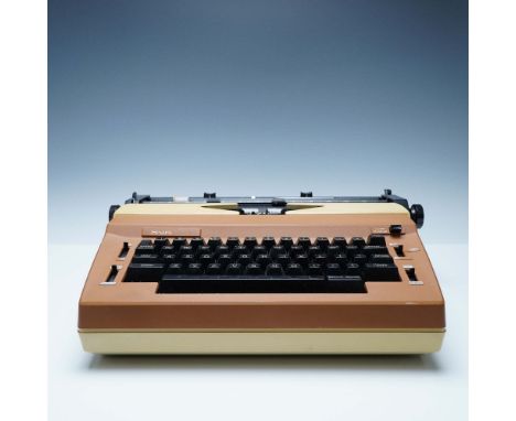 A Sears Commentator I electric typewriter, Model No. 268.53941, featuring a retro brown and beige design with black keys and 