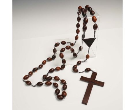 A traditional handcrafted rosary featuring richly polished oval wooden beads strung on dark metal chain links. The crucifix i