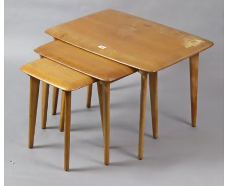 A light oak nest of three rectangular occasional tables, each on four square tapered legs.