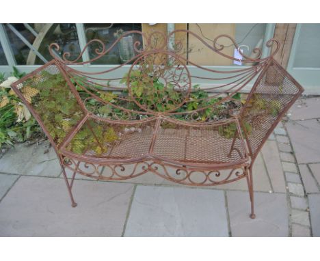An ornate metalwork bench - 138cm wide x 99cm tall