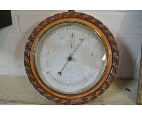 An oak Aneroid Barometer with Thermometer - 28 cm diameter